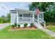 Charming home with covered porch, landscaped front yard, and American flag at 515 Myrtle Ave, Chester, SC 29706