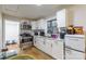 Bright kitchen with stainless steel appliances and white cabinets at 515 Myrtle Ave, Chester, SC 29706