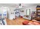 Open living room with hardwood floors, fan, and view into the kitchen at 515 Myrtle Ave, Chester, SC 29706
