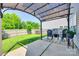 Backyard with a covered patio area, comfortable seating, a privacy fence, and lush greenery at 5228 Tomsie Efird Ln, Charlotte, NC 28269