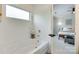 Modern bathroom with a soaking tub, white fixtures, and a view into the bedroom at 5228 Tomsie Efird Ln, Charlotte, NC 28269