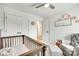 Neutral Bedroom with a crib, glider chair, and accent wall decorations and patterns at 5228 Tomsie Efird Ln, Charlotte, NC 28269