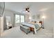 Bright bedroom with a large window, ceiling fan, and a comfortable bed with stylish decor at 5228 Tomsie Efird Ln, Charlotte, NC 28269