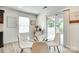 Cozy dining area with a glass table, modern chairs, and sliding glass doors to the outdoor space at 5228 Tomsie Efird Ln, Charlotte, NC 28269