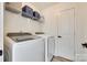 Laundry room with modern washer and dryer units, and a door to a closet at 5228 Tomsie Efird Ln, Charlotte, NC 28269
