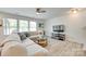 Inviting living room featuring ample natural light and a comfortable sectional sofa at 5228 Tomsie Efird Ln, Charlotte, NC 28269