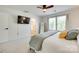 Spacious main bedroom featuring a ceiling fan and a view of the ensuite bathroom at 5228 Tomsie Efird Ln, Charlotte, NC 28269