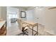 Bright home office open to living area with wood-look floors and neutral walls at 5228 Tomsie Efird Ln, Charlotte, NC 28269