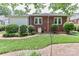 Well-maintained backyard with lush greenery, shrubs, and a brick walkway at 536 Carroll St, Statesville, NC 28625