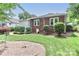 Well-maintained backyard with lush greenery, shrubs, and a brick walkway at 536 Carroll St, Statesville, NC 28625