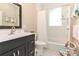 Charming bathroom featuring a black vanity, framed mirror, and hexagon tile floor at 536 Carroll St, Statesville, NC 28625