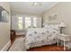 Cozy bedroom with three bright windows, hardwood floors, a floral comforter and white accents, creating a relaxing atmosphere at 536 Carroll St, Statesville, NC 28625