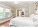 Bright bedroom with two windows, hardwood floors, and access to an adjoining bathroom at 536 Carroll St, Statesville, NC 28625