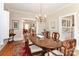 Bright dining room with hardwood floors, chandelier, and seating for six at 536 Carroll St, Statesville, NC 28625