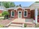 Traditional brick home featuring a tiled porch, manicured landscaping, and a security system at 536 Carroll St, Statesville, NC 28625