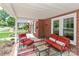 Charming front porch with red brick accents and cozy outdoor furniture at 536 Carroll St, Statesville, NC 28625