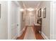 Long hallway featuring hardwood floors, neutral walls with tasteful art, leading to various rooms in a well-maintained home at 536 Carroll St, Statesville, NC 28625