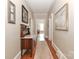 Inviting hallway with hardwood floors, neutral walls adorned with artwork, and a vintage furniture piece for added charm at 536 Carroll St, Statesville, NC 28625