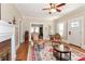 Open-concept living room with hardwood floors and fireplace, flowing into dining area at 536 Carroll St, Statesville, NC 28625