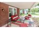 Covered porch with brick columns, comfortable seating, and decorative rugs at 536 Carroll St, Statesville, NC 28625