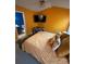 Bedroom with orange walls, modern furniture and doorway to blue bathroom at 571 Goldstaff Ln, Charlotte, NC 28273