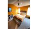 Bright bedroom with orange walls, ceiling fan, and modern furniture at 571 Goldstaff Ln, Charlotte, NC 28273