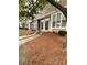 Two story tan townhouse with stone accents and landscaped front yard at 571 Goldstaff Ln, Charlotte, NC 28273