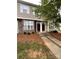 Charming two-story townhouse featuring stone accents and landscaped front yard at 571 Goldstaff Ln, Charlotte, NC 28273