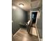 Gray upstairs hallway featuring wood floors and a decorative rug at 571 Goldstaff Ln, Charlotte, NC 28273