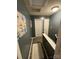 Upstairs hallway features gray walls, white trim, wood floors and art at 571 Goldstaff Ln, Charlotte, NC 28273