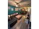 Spacious living room with cozy sectional couch, wood-look floors, and teal accent wall at 571 Goldstaff Ln, Charlotte, NC 28273