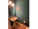 Stylish half-bathroom with a pedestal sink and updated lighting fixtures at 571 Goldstaff Ln, Charlotte, NC 28273