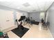 Finished basement area with workout equipment, neutral colors, and tile floor at 6302 Dwayne Starnes Dr, Hickory, NC 28602