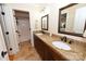 Bathroom with double sinks, granite countertop, wood cabinets, and a separate shower and toilet area at 6302 Dwayne Starnes Dr, Hickory, NC 28602
