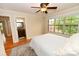 Bright bedroom with hardwood floors, ceiling fan, and large window overlooking the trees at 6302 Dwayne Starnes Dr, Hickory, NC 28602