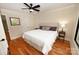 Bedroom with hardwood floors, neutral paint, and a serene atmosphere, complete with side tables and lamps at 6302 Dwayne Starnes Dr, Hickory, NC 28602