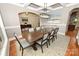 Elegant dining room featuring a long wooden table, seating for eight, and a decorative coffered ceiling at 6302 Dwayne Starnes Dr, Hickory, NC 28602