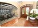 Inviting foyer with a decorative stone arch, a wood door, and a view into the formal dining room at 6302 Dwayne Starnes Dr, Hickory, NC 28602