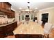 Open kitchen with granite island, stone fireplace, stainless steel appliances, and coffered ceiling at 6302 Dwayne Starnes Dr, Hickory, NC 28602