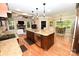A spacious kitchen featuring an eat-in island, stainless steel appliances, and a cozy living room area at 6302 Dwayne Starnes Dr, Hickory, NC 28602