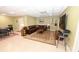Finished basement living room area with a comfortable leather couch, gaming table, and a large TV at 6302 Dwayne Starnes Dr, Hickory, NC 28602