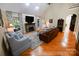 Bright living room with stone fireplace, hardwood floors, and elegant furnishings, offering a cozy and inviting space at 6302 Dwayne Starnes Dr, Hickory, NC 28602