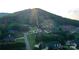 Scenic neighborhood view showcasing the house nestled among lush trees and rolling hills at 6302 Dwayne Starnes Dr, Hickory, NC 28602