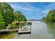 Wonderful lake view featuring private boat dock with lifts, lush greenery, and clear water at 669 Kenway Loop, Mooresville, NC 28117