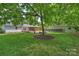 Beautiful backyard with a large shade tree and patio spaces, providing ample room for outdoor activities at 6938 Wrentree Dr, Charlotte, NC 28210