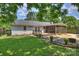 Backyard with a wooden deck and a screened in porch and nice landscaping at 6938 Wrentree Dr, Charlotte, NC 28210