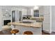 Bright kitchen boasts granite counters, stainless steel appliances, and a breakfast bar with stools at 6938 Wrentree Dr, Charlotte, NC 28210