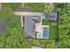 Stunning aerial view of a home with a pool, patio, putting green, and lush landscaping in a desirable neighborhood at 6946 Woodstock Dr, Charlotte, NC 28210