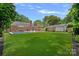 Green backyard featuring a swimming pool and outdoor seating at 6946 Woodstock Dr, Charlotte, NC 28210