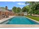 Inviting backyard pool featuring modern seating, a lush lawn, and a charming outdoor space perfect for relaxation at 6946 Woodstock Dr, Charlotte, NC 28210